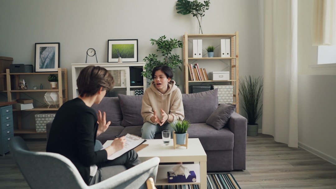Two people having a conversation during an interview with a notebook